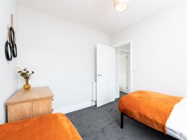 A bedroom with two beds and a dresser at 23 Trafalgar Road in Scarborough