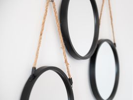 Three circular mirrors hanging with rope on a wall at 23 Trafalgar Road in Scarborough