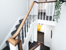 A staircase with a wooden handrail and a doorway at 23 Trafalgar Road, Scarborough