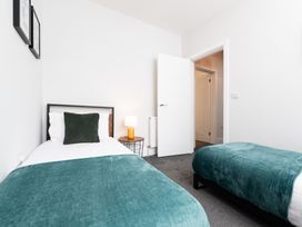 A bedroom with two beds and a lamp at 23 Trafalgar Road in Scarborough