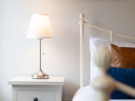A lamp on a nightstand beside a bed at 23 Trafalgar Road in Scarborough