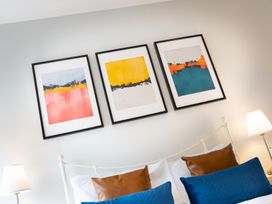 A bedroom with framed artwork above a bed at 23 Trafalgar Road in Scarborough