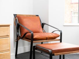 A chair and ottoman in a living room at 23 Trafalgar Road Scarborough
