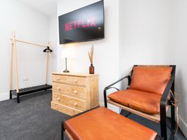 A living room with a television and furniture at 23 Trafalgar Road in Scarborough