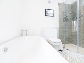 A bathroom with a bathtub, shower, and toilet at 23 Trafalgar Road, Scarborough