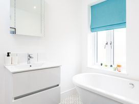 A bathroom with a bathtub and sink at 23 Trafalgar Road in Scarborough