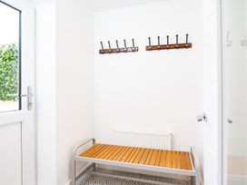 A hallway with a bench and coat hooks at 23 Trafalgar Road Scarborough