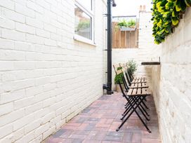A garden with benches and plant pots at 23 Trafalgar Road in Scarborough