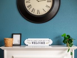A living room with a clock and decorative items at 53A Hampton Road in Scarborough