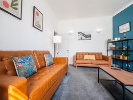 A living room with sofas and a lamp at 53A Hampton Road Scarborough