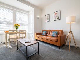 A living room with a sofa and dining table at 53A Hampton Road in Scarborough