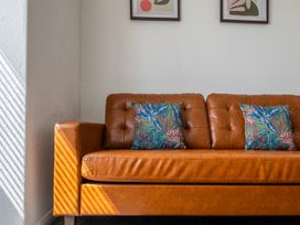 A sofa with cushions in a living room at 53A Hampton Road Scarborough