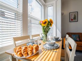 A dining room with a table set for breakfast at 53A Hampton Road Scarborough