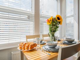 A dining room with a table set for breakfast at 53A Hampton Road in Scarborough