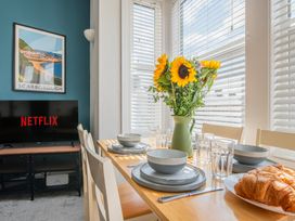A dining room with a table set for breakfast at 53A Hampton Road, Scarborough