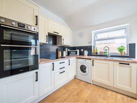 A kitchen with appliances and cabinets at 53A Hampton Road Scarborough