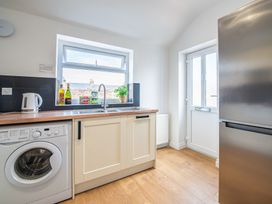 A kitchen with a sink and washing machine at 53A Hampton Road in Scarborough