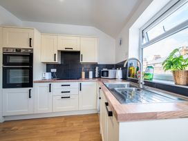 A kitchen with countertop, oven, and sink at 53A Hampton Road Scarborough