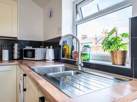 A kitchen with a sink and appliances at 53A Hampton Road in Scarborough