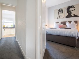 A bedroom with a bed and wall art at 53A Hampton Road Scarborough