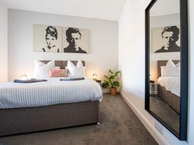 A bedroom with a bed and art on the walls at 53A Hampton Road Scarborough