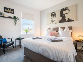A bedroom with bed and wall art at 53A Hampton Road, Scarborough