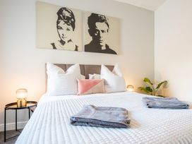 A bedroom with a bed and wall art at 53A Hampton Road Scarborough