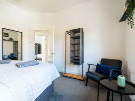 A bedroom featuring a bed with towels and a shelf at 53A Hampton Road Scarborough