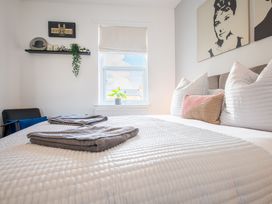 A bedroom with a bed and a shelf in the background at 53A Hampton Road in Scarborough
