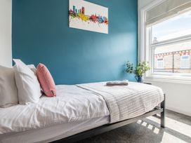A bedroom with a bed and a window at 53A Hampton Road Scarborough