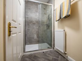 A bathroom with a shower and towels at 53A Hampton Road Scarborough