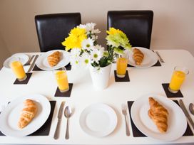 A dining table with croissants and orange juice at 53 Hampton Road Scarborough
