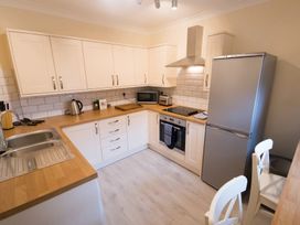 A kitchen with a stove and refrigerator at 53 Hampton Road Scarborough