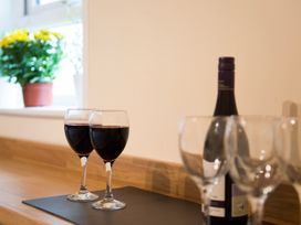Two wine glasses and a bottle of red wine on a countertop at 53 Hampton Road Scarborough