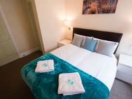 A bedroom with a bed and bedside furniture at 53 Hampton Road Scarborough