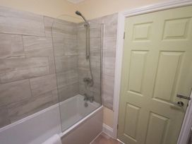 A bathroom with a bathtub and shower at 53 Hampton Road, Scarborough