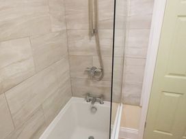 A bathtub with a shower in a bathroom at 53 Hampton Road Scarborough
