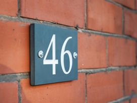 Number 46 plaque on a brick wall at 46 Ashville Avenue Scarborough