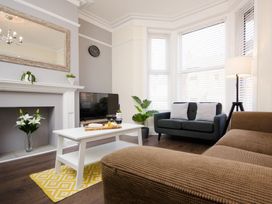 A living room with a sofa and a coffee table at 46 Ashville Avenue in Scarborough