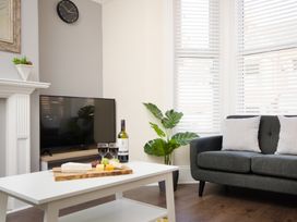A living room with a couch and a coffee table at 46 Ashville Avenue, Scarborough