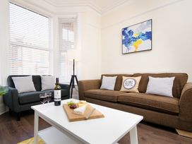 A living room with a sofa and a coffee table at 46 Ashville Avenue Scarborough