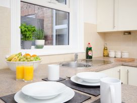 A kitchen with a sink, fruit bowl, and drinkware at 46 Ashville Avenue Scarborough
