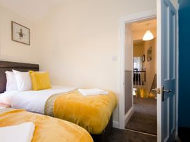 A bedroom with two beds and a view of the hallway at 46 Ashville Avenue Scarborough