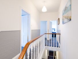 A hallway with stairs and doors at 46 Ashville Avenue Scarborough
