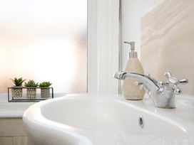 A sink with a tap and plants on a shelf at 46 Ashville Avenue Scarborough