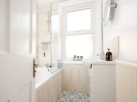 A bathroom with a bathtub and sink at 46 Ashville Avenue in Scarborough