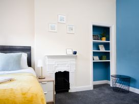 A bedroom with a bed and shelves at 46 Ashville Avenue in Scarborough