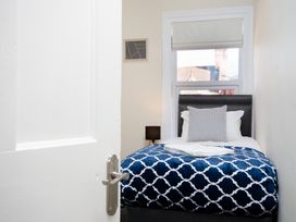 A bedroom with a bed and bedside lamp at 46 Ashville Avenue Scarborough