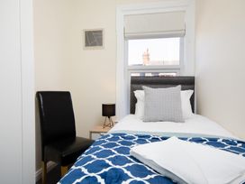 A bedroom with a bed and a chair at 46 Ashville Avenue, Scarborough