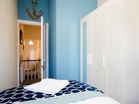 A bedroom with a bed and wardrobe at 46 Ashville Avenue Scarborough